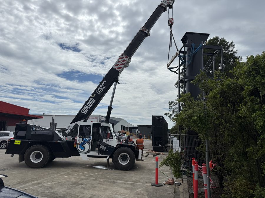 Mobile crane lifting an LED structure into position on site