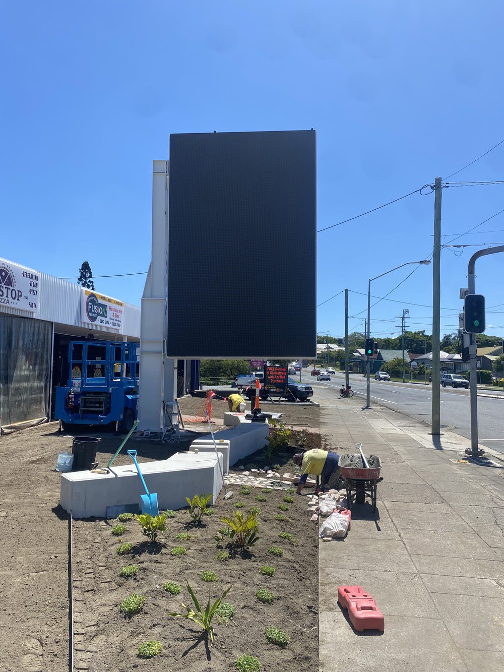 Finished LED screen structure on a landscaped corner site